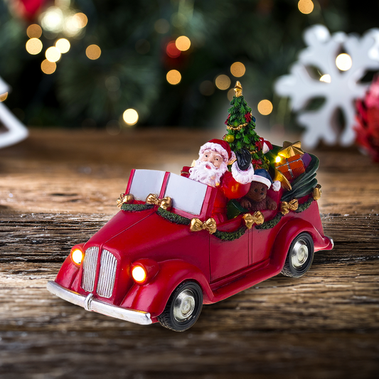 Weihnachtsmann im Auto mit sich drehendem Baum